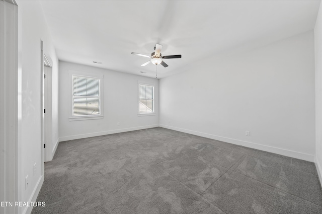 spare room with baseboards, carpet floors, and ceiling fan