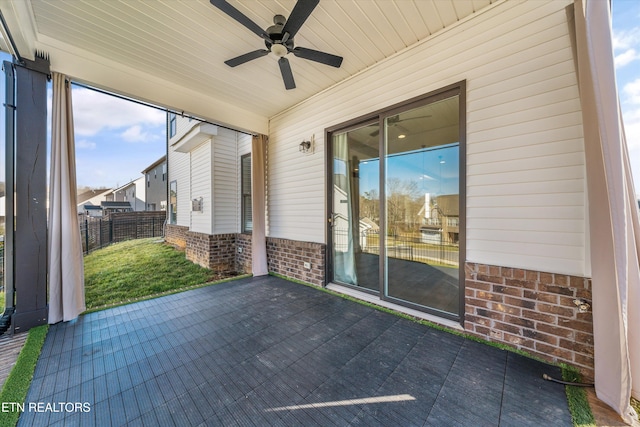 view of patio / terrace featuring a ceiling fan and fence