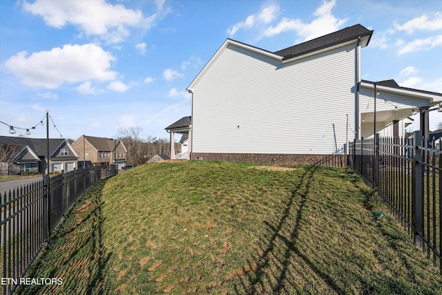 view of yard with a fenced backyard and a residential view