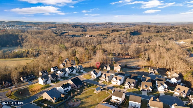 aerial view with a wooded view and a residential view