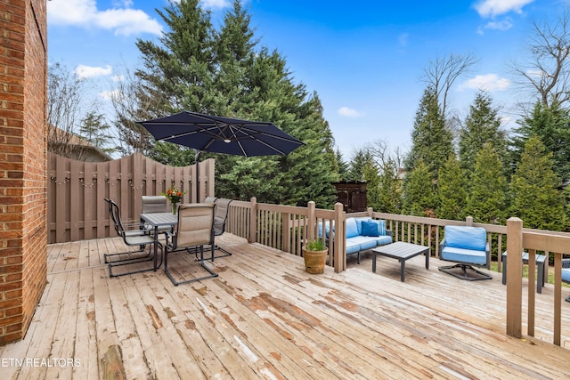 wooden deck featuring fence and an outdoor hangout area