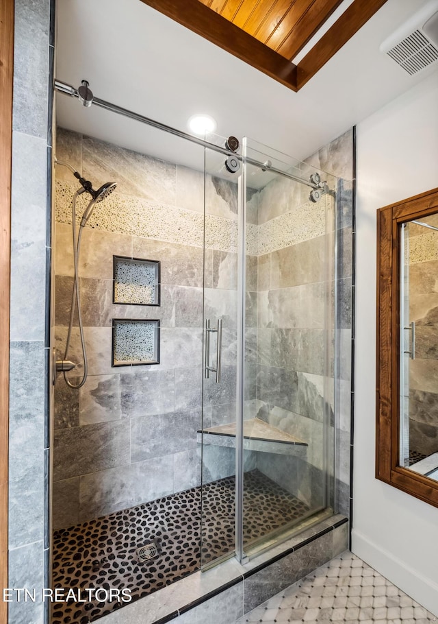 full bathroom featuring a shower stall, visible vents, and baseboards