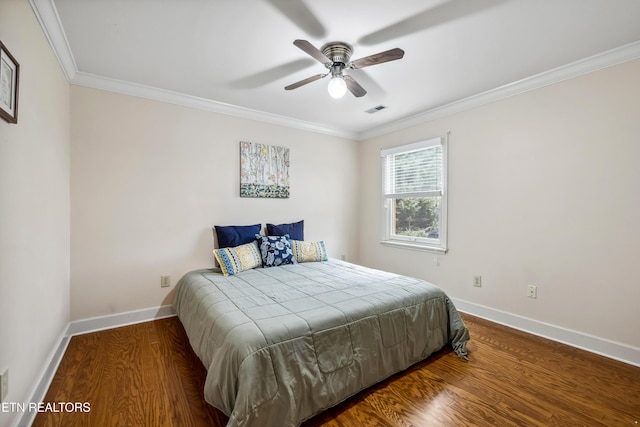 bedroom featuring baseboards, visible vents, wood finished floors, and ornamental molding