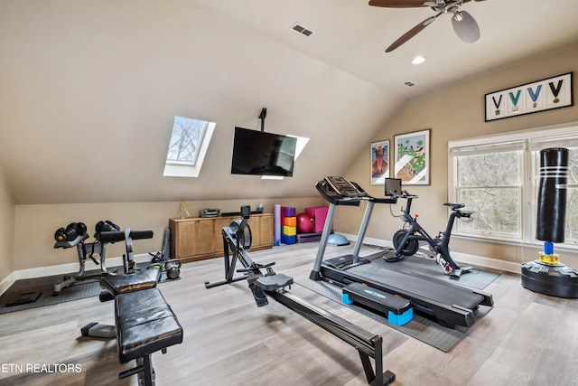 exercise room with light wood-style floors, lofted ceiling, and baseboards