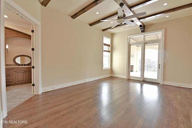 spare room with baseboards, light wood finished floors, recessed lighting, ceiling fan, and beamed ceiling