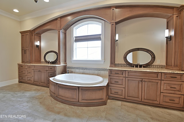 full bath featuring two vanities, ornamental molding, a sink, recessed lighting, and a bath