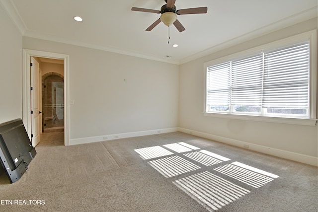 carpeted spare room with recessed lighting, crown molding, baseboards, and ceiling fan