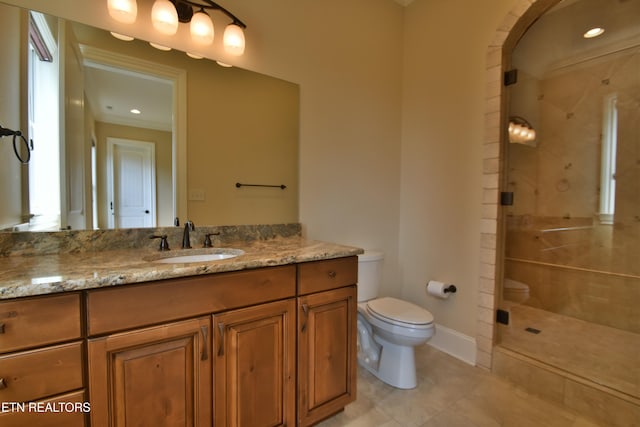 full bathroom with tile patterned flooring, a shower stall, baseboards, toilet, and vanity