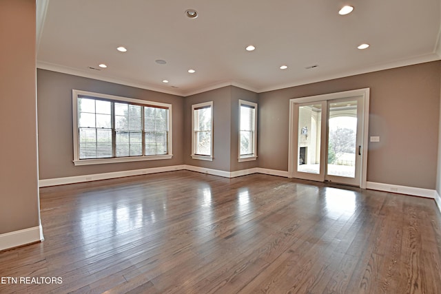 spare room featuring a healthy amount of sunlight and ornamental molding