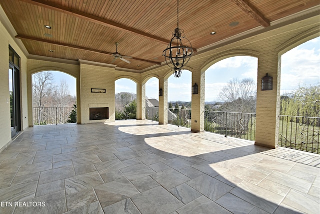 view of patio / terrace with a ceiling fan and a fireplace