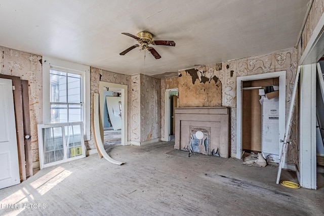 unfurnished living room featuring a ceiling fan