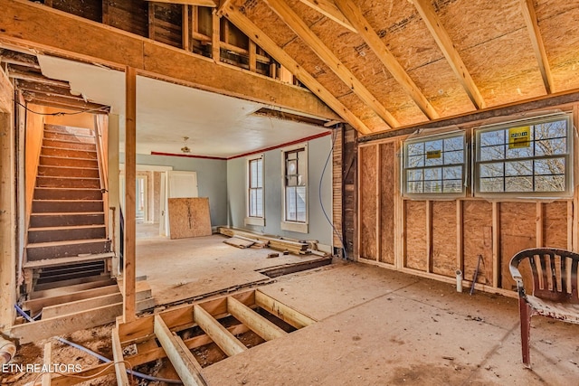 misc room with stairway and vaulted ceiling