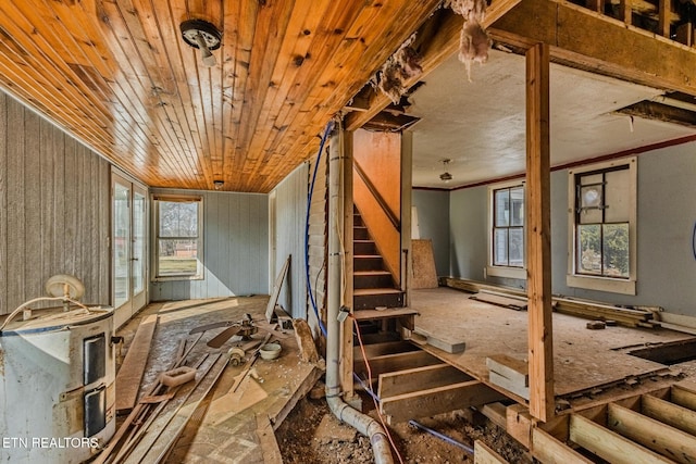 interior space featuring ornamental molding, wood ceiling, and stairway