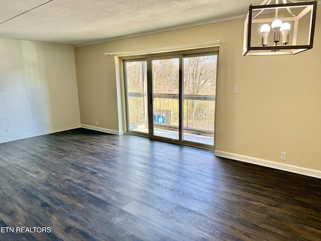 unfurnished room with a textured ceiling, baseboards, and dark wood-type flooring