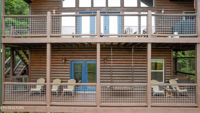 rear view of property with faux log siding