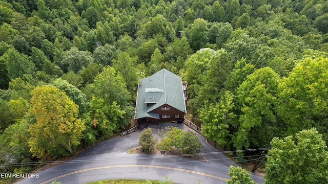 drone / aerial view featuring a wooded view