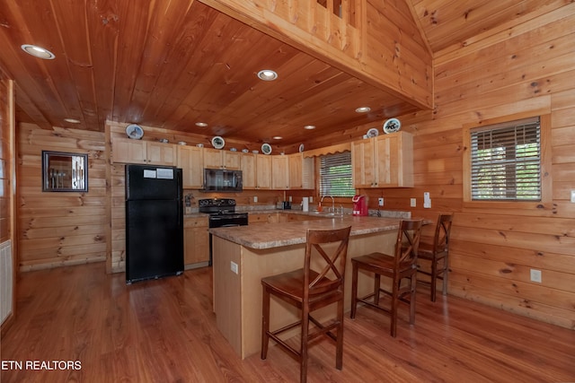 kitchen featuring wooden ceiling, a peninsula, light brown cabinetry, black appliances, and a sink