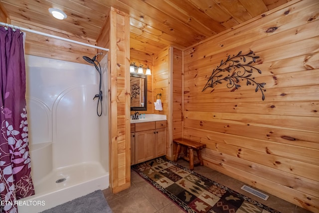 full bathroom featuring a stall shower, wood ceiling, visible vents, and wooden walls