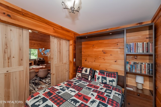 bedroom with wood walls