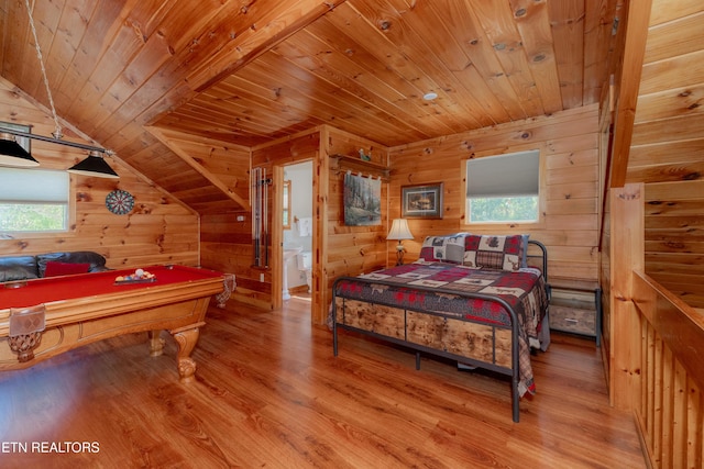 bedroom with lofted ceiling, wood walls, billiards, wood finished floors, and wood ceiling