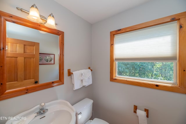half bathroom with a sink and toilet