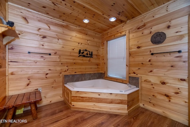 full bathroom with a garden tub, recessed lighting, wood walls, wood finished floors, and wood ceiling