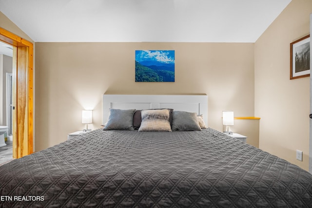 unfurnished bedroom with lofted ceiling