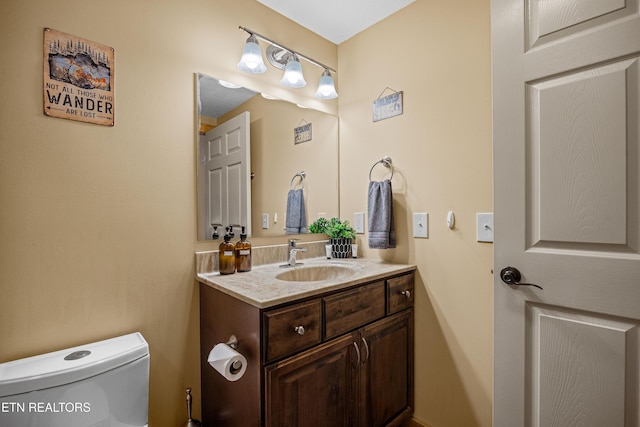 bathroom featuring toilet and vanity