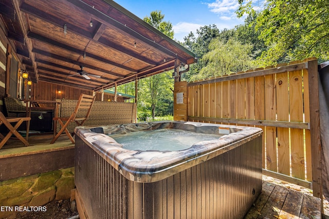 wooden deck featuring a hot tub