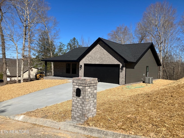 view of front of house with brick siding, roof with shingles, concrete driveway, central AC, and a garage