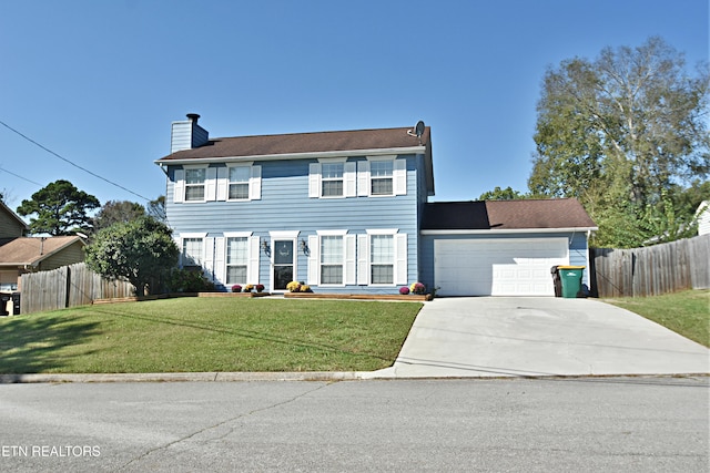 colonial inspired home featuring driveway, a chimney, an attached garage, fence, and a front yard