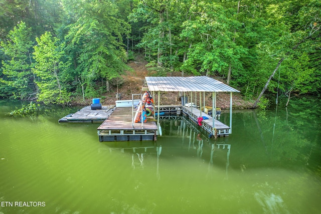 dock area featuring a view of trees and a water view