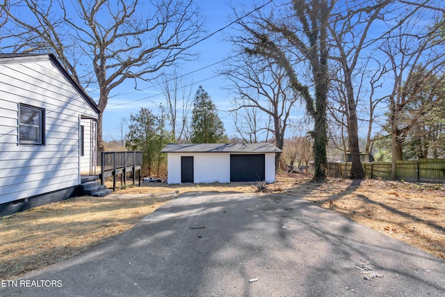 view of side of home with fence and an outdoor structure