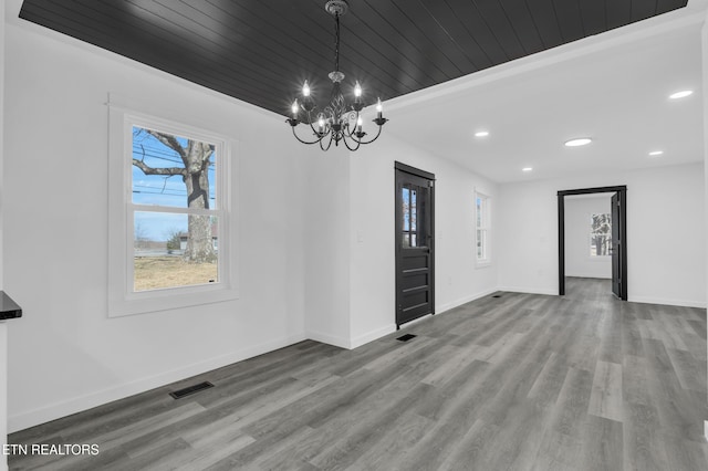 interior space with wooden ceiling, visible vents, baseboards, and wood finished floors