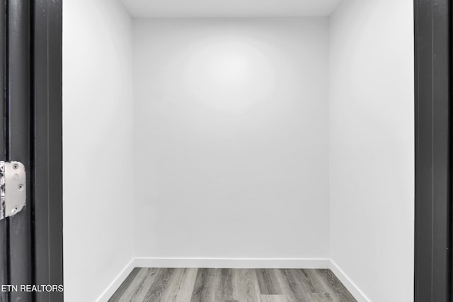 spare room with wood finished floors and baseboards