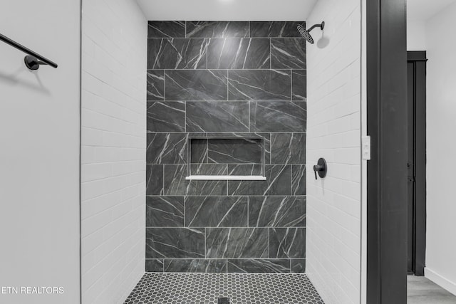 full bathroom with a tile shower