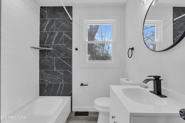 bathroom with baseboards, plenty of natural light, toilet, and tub / shower combination