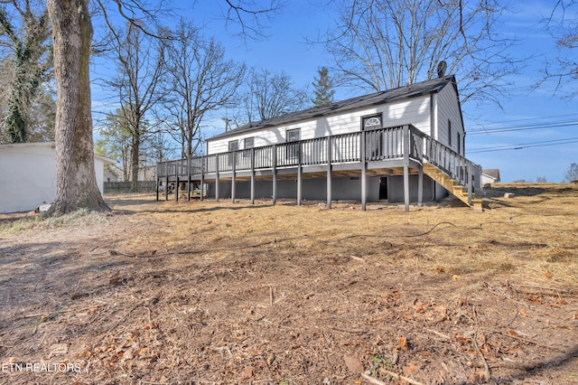 rear view of house with stairway and a wooden deck