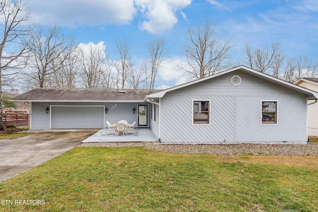 ranch-style house with a garage, concrete driveway, and a front yard