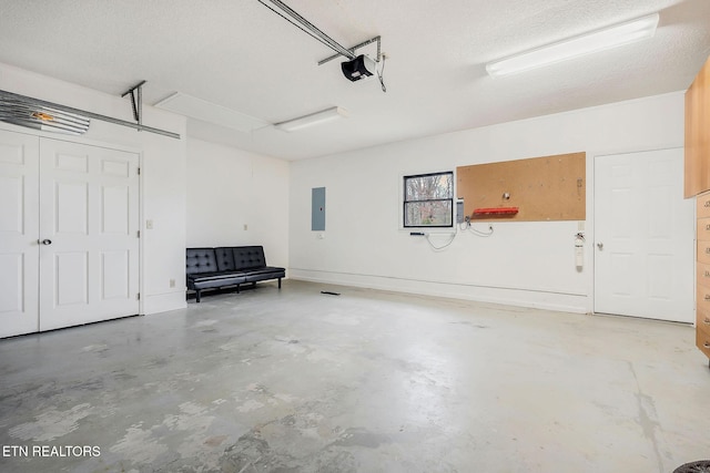 garage with a garage door opener, electric panel, and baseboards