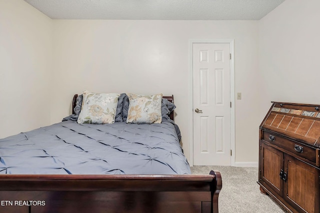 carpeted bedroom featuring a textured ceiling