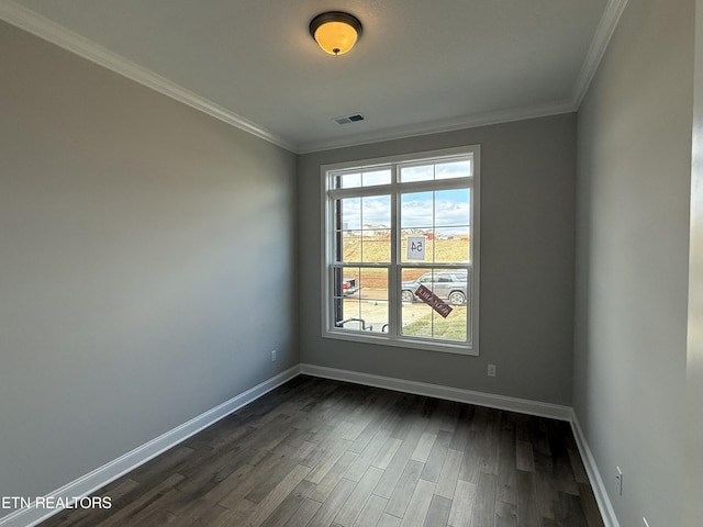 unfurnished room with crown molding, dark wood-style flooring, visible vents, and baseboards