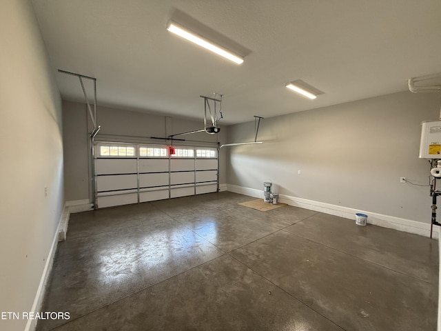 garage featuring a garage door opener and baseboards