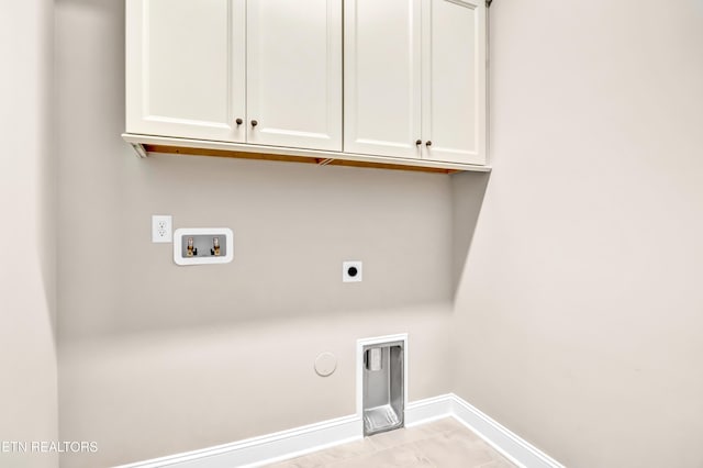 laundry area with hookup for an electric dryer, cabinet space, baseboards, gas dryer hookup, and hookup for a washing machine