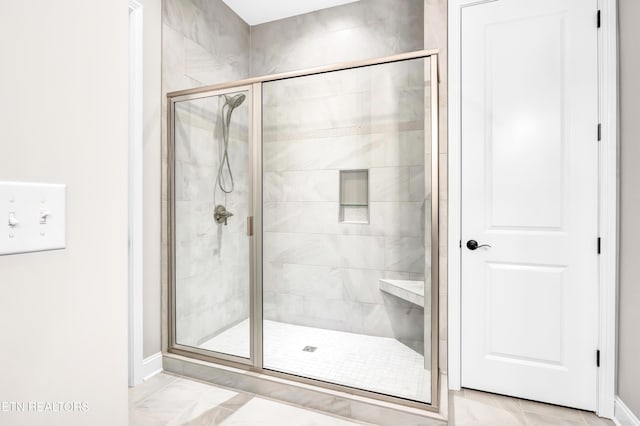 full bath with marble finish floor and a stall shower