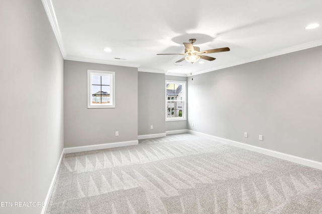 unfurnished room with baseboards, light carpet, ceiling fan, and crown molding