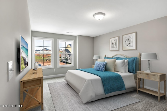 bedroom featuring baseboards and carpet floors