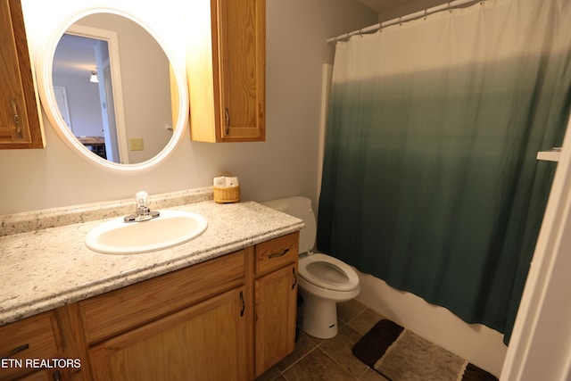 bathroom with tile patterned flooring, vanity, and toilet