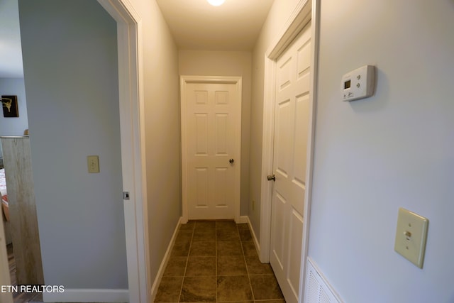hallway featuring baseboards