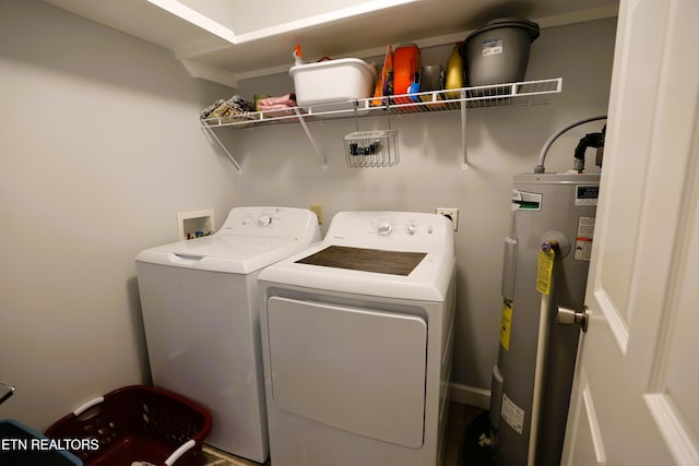 washroom with electric water heater and washing machine and clothes dryer